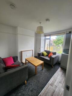 A cozy living room featuring two comfortable gr...