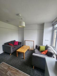 A cozy living room with two grey sofas accented...
