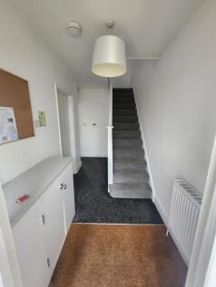 A neat and well-maintained hallway featuring cl...