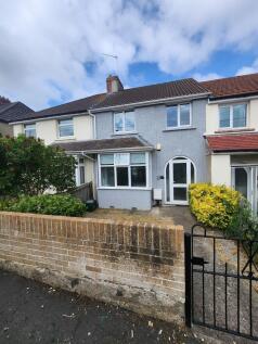 A charming terraced house with a neat front yar...