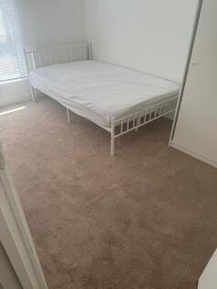 A bright and clean double bedroom featuring a w...