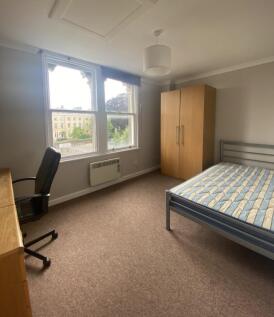 Bright and spacious double bedroom featuring la...