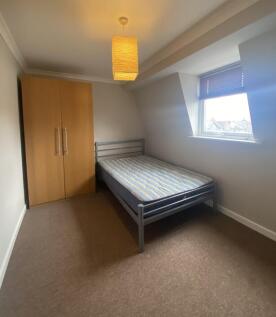 This inviting double bedroom features a comfort...