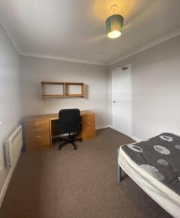 Bright and spacious double bedroom featuring a ...