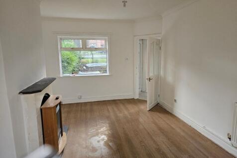 A bright living room with a large window offeri...