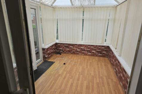 Bright communal lounge featuring large windows ...