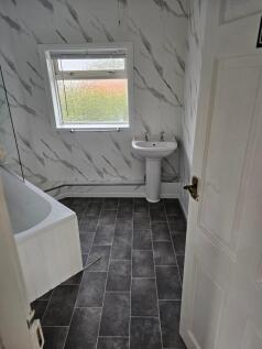A clean and modern bathroom featuring a white p...