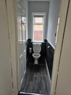 A compact and tidy single toilet room with a wh...