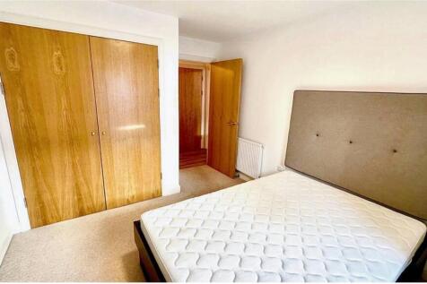 Bright double bedroom featuring a large window ...