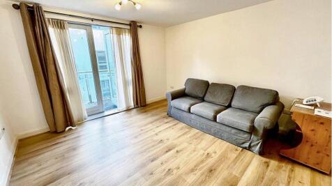 Bright and inviting living room with large wind...