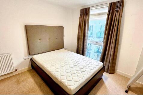 Bright double bedroom featuring a large window ...