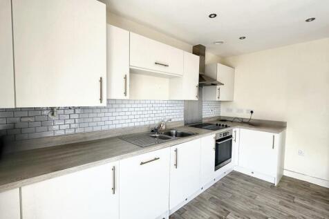 A modern kitchen featuring a clean, sleek desig...