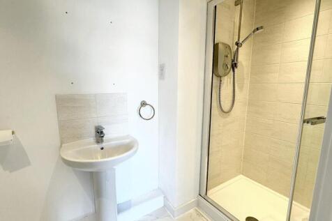 Bright and clean bathroom featuring a modern gl...