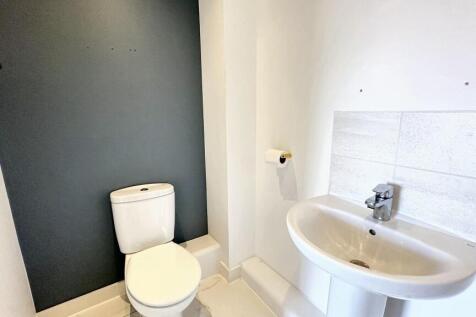 Bright and clean single toilet with modern fixt...