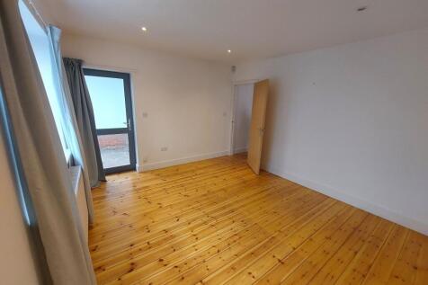 A bright and clean double bedroom featuring pol...