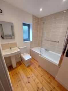 Bright and modern bathroom featuring a clean wh...
