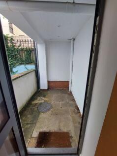 A small outdoor garden area with stone paving a...