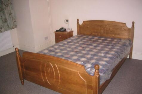 Cozy double bedroom featuring a classic wooden ...