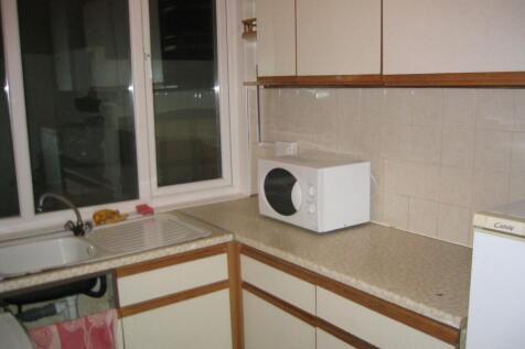 Compact kitchen featuring ample countertop spac...