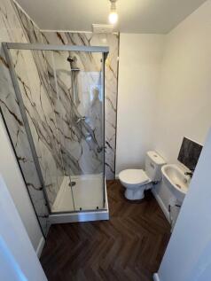 A modern bathroom featuring a stylish shower en...