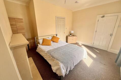 A bright and inviting double bedroom featuring ...