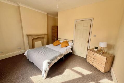 A bright and inviting double bedroom featuring ...