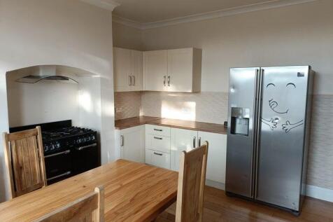 Bright and welcoming kitchen featuring modern w...