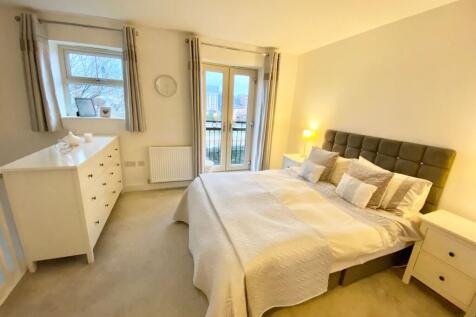 Bright and spacious master bedroom featuring a ...