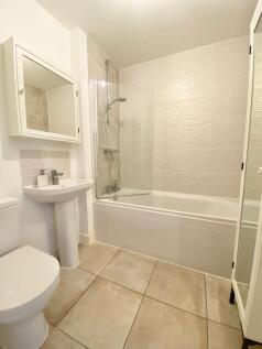 A modern and clean bathroom suite featuring a s...