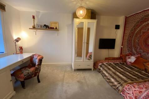 Cozy and warmly decorated bedroom featuring a c...