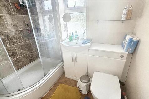Bright and modern bathroom suite featuring a sp...