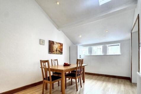 Bright and tidy contemporary living room featur...