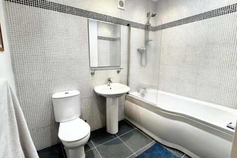 Bright and clean bathroom featuring a modern wh...