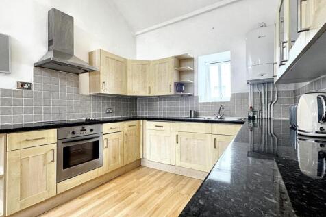 Bright and modern kitchen featuring ample count...