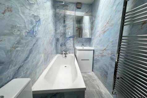 A stylish and modern bathroom featuring elegant...