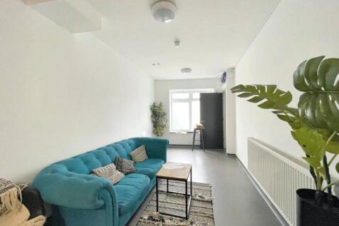 A bright and modern living room featuring a sty...