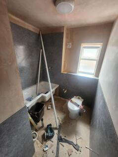 A bathroom under renovation featuring a bathtub...