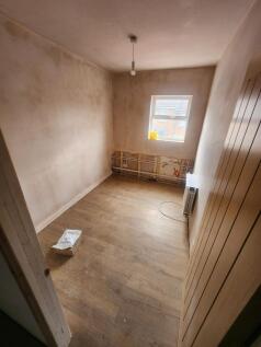 A small, bright room with natural light pouring...