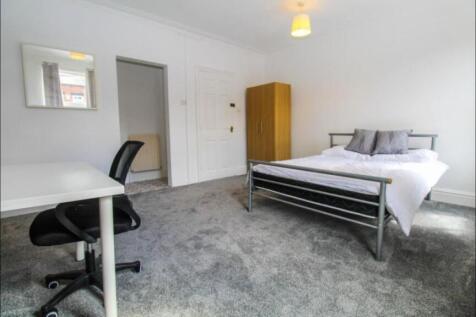 Bright and airy master bedroom featuring a comf...