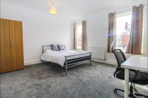 Bright and airy master bedroom featuring a comf...