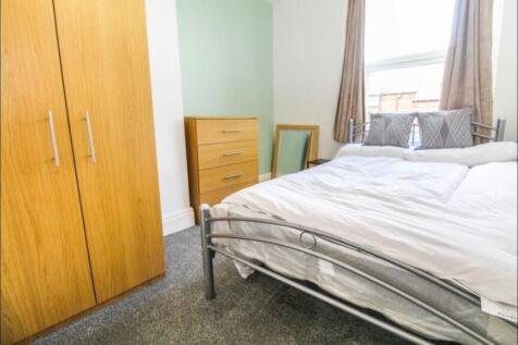 Bright and cozy double bedroom featuring a comf...