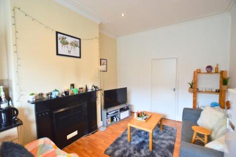 A cozy and well-kept living room featuring a co...