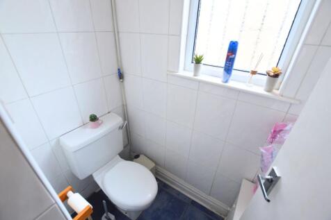 Bright and tidy single toilet room featuring wh...
