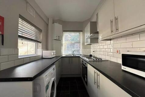 Modern galley kitchen with ample counter space,...