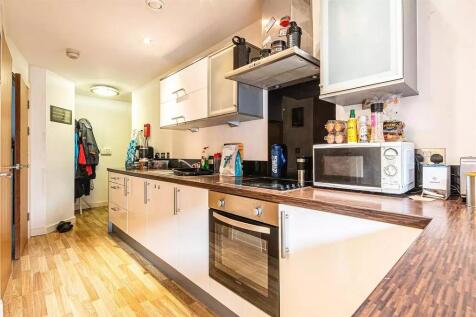Bright and modern kitchen featuring sleek cabin...
