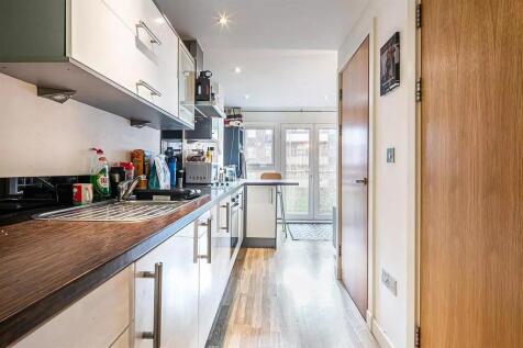 A modern kitchen featuring a long countertop wi...