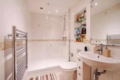 Bright and modern bathroom suite featuring a sp...