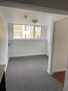 Bright and clean single bedroom with a large wi...