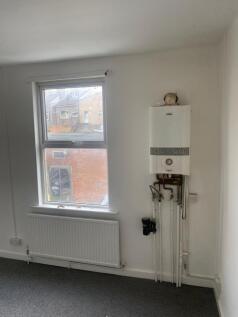 A clean and bright hallway featuring a large wi...