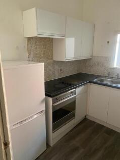 A compact and functional kitchen featuring mode...